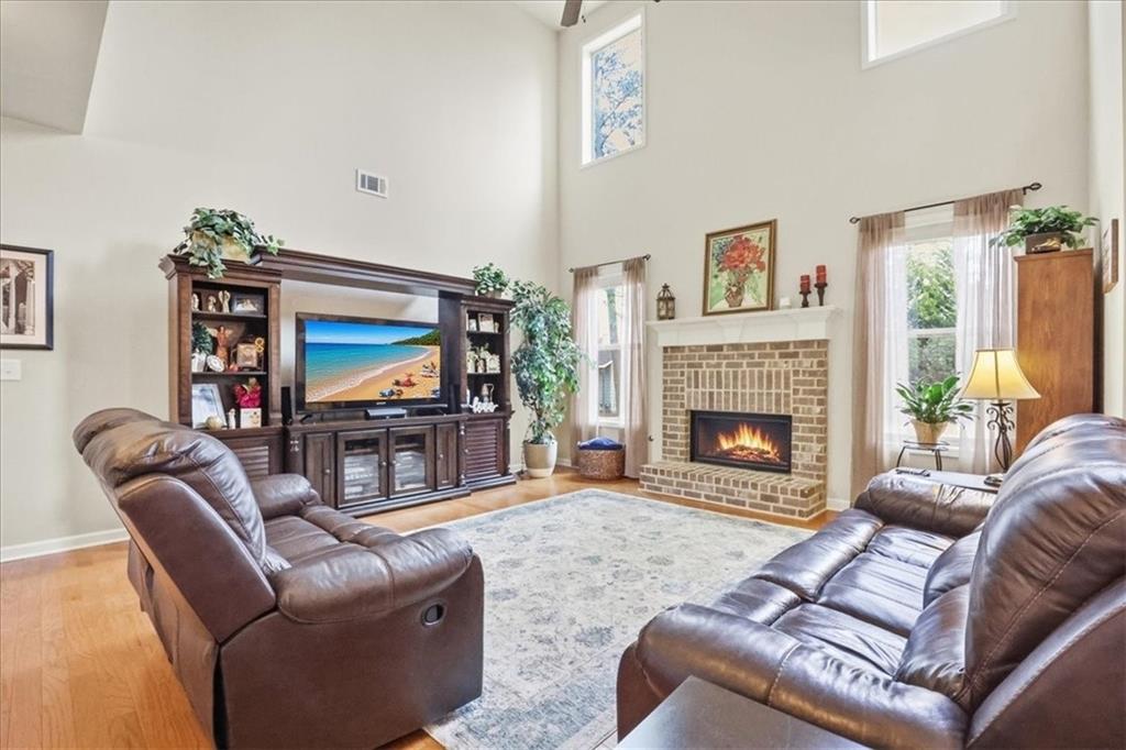 525 Widgeon Way Jefferson, GA 30549 - Photo 14 of 65 a living room with furniture a flat screen tv and a fireplace