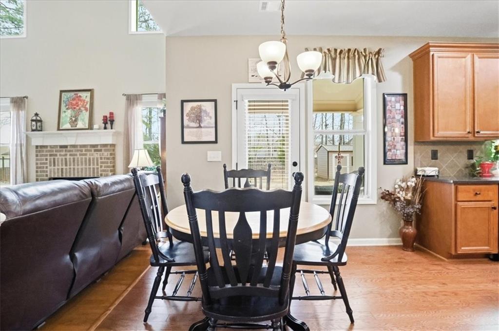 525 Widgeon Way Jefferson, GA 30549 - Photo 18 of 65 a view of a dining room with furniture a chandelier and wooden floor