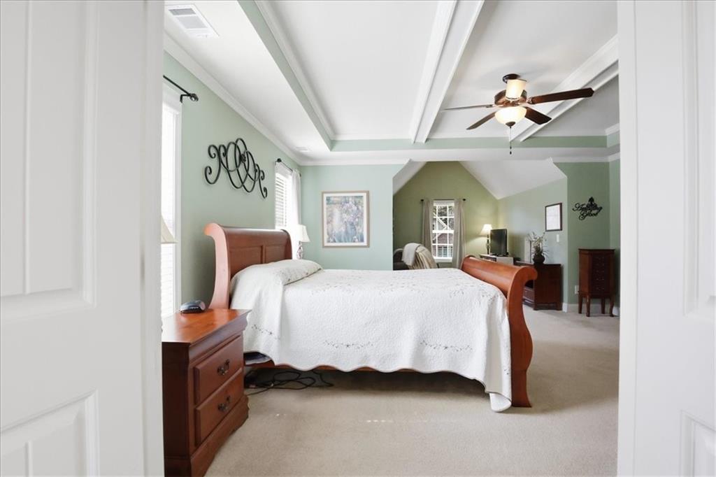 525 Widgeon Way Jefferson, GA 30549 - Photo 43 of 65 a spacious bedroom with a bed and a chandelier