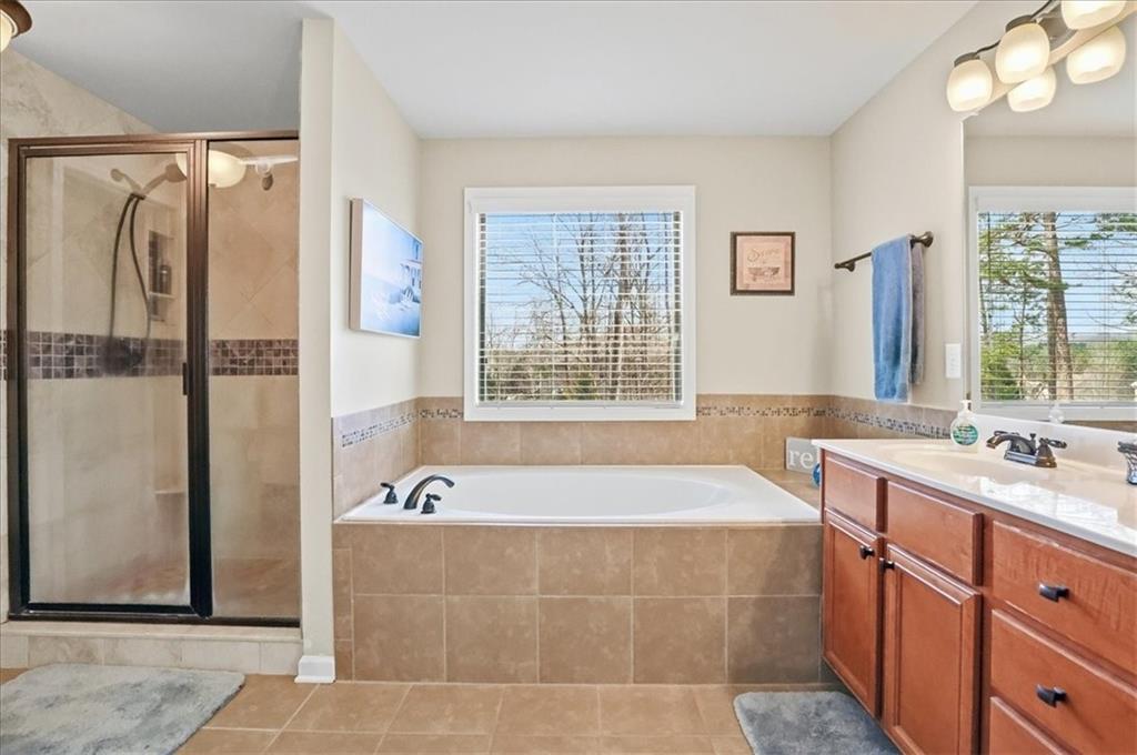 525 Widgeon Way Jefferson, GA 30549 - Photo 46 of 65 a spacious bathroom with a tub sink and mirror