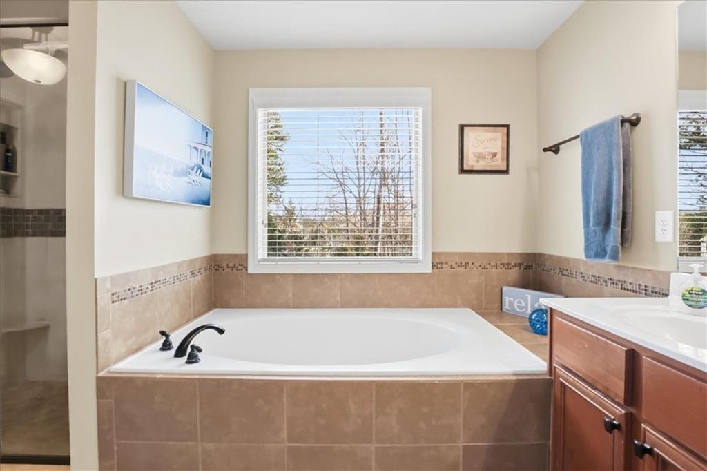 525 Widgeon Way Jefferson, GA 30549 - Photo 49 of 65 a bathroom with bathtub and window