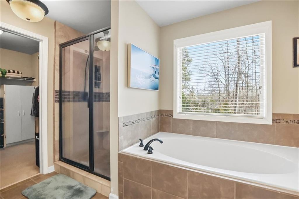 525 Widgeon Way Jefferson, GA 30549 - Photo 50 of 65 a bathroom with a tub a sink and a shower