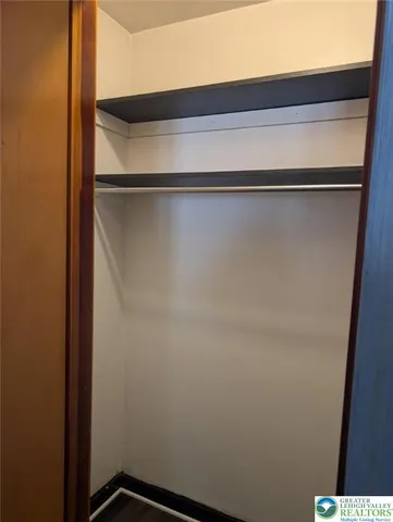 a view of empty room with closet