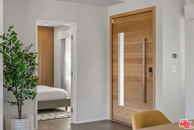 a bedroom with a bed and a potted plant