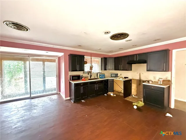 a living room with stainless steel appliances kitchen island granite countertop a large kitchen counter top space and stainless steel appliances