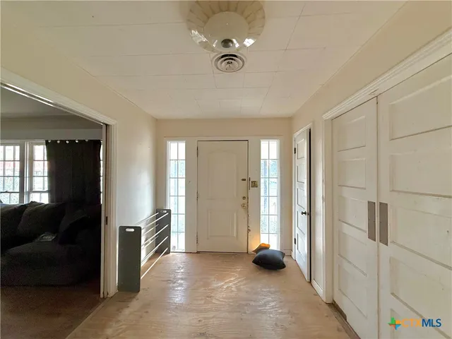 a view of a livingroom with a ceiling fan and window