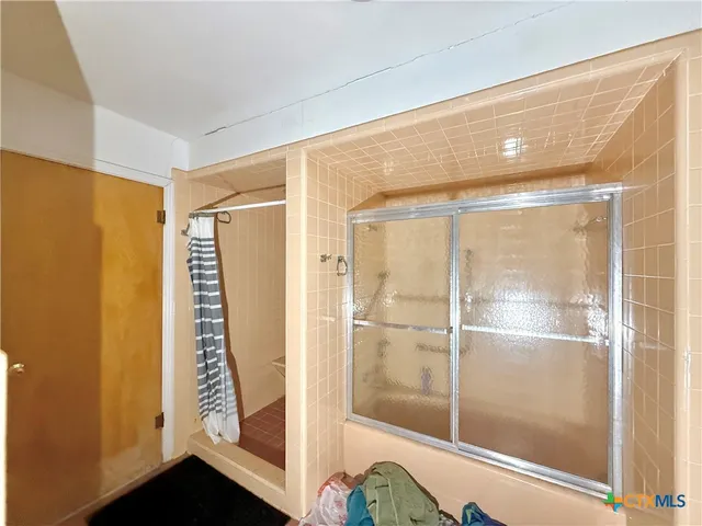 a bathroom with a shower and a sink