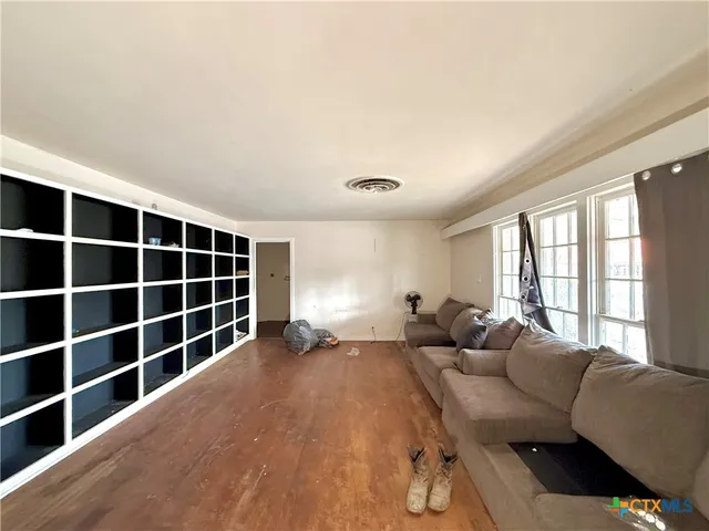 a living room with furniture windows and a flat screen tv