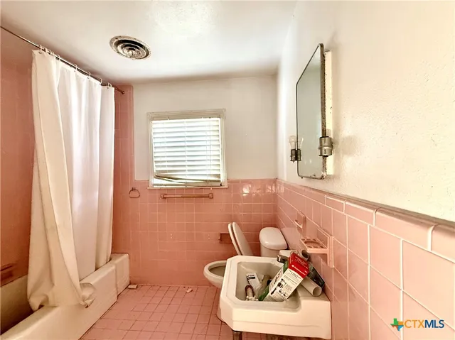 a bathroom with a sink and a window