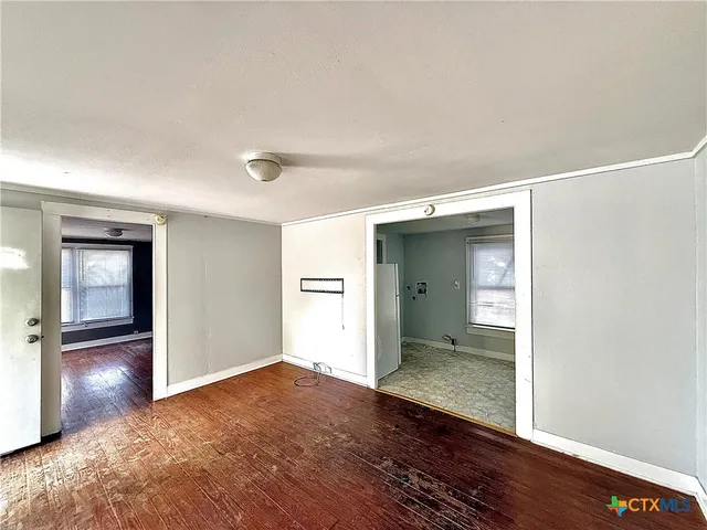 a view of a room with wooden floor and closet