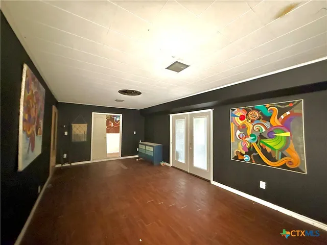 en view interior of the house with floor to ceiling window and ceiling fan