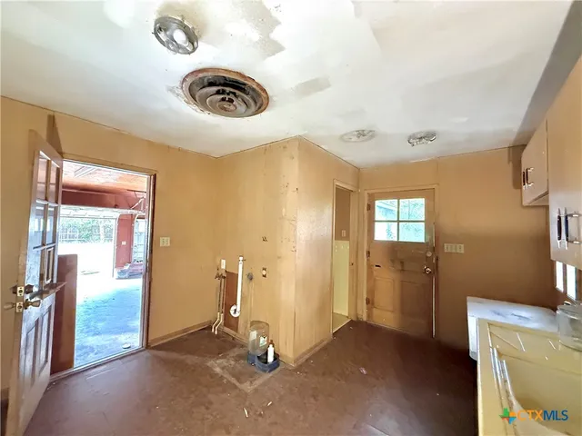 a view of a storage & utility room with a window