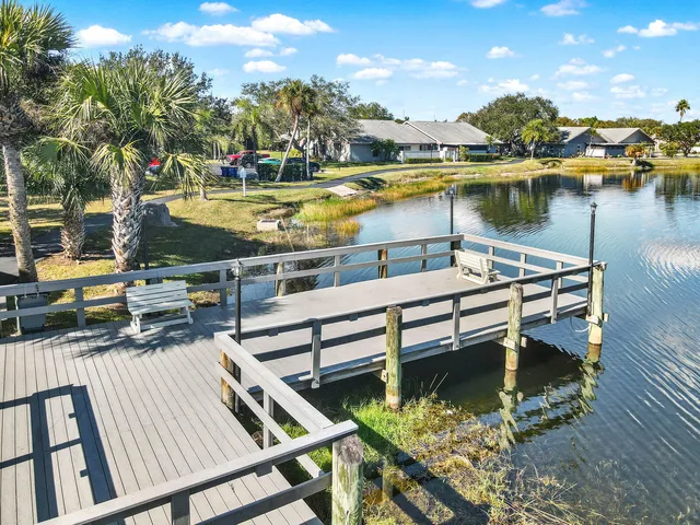 a view of a lake with couches chairs