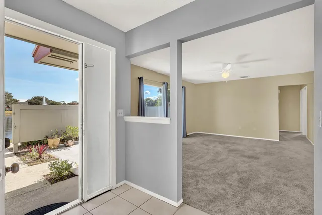 an empty room with closet and large windows
