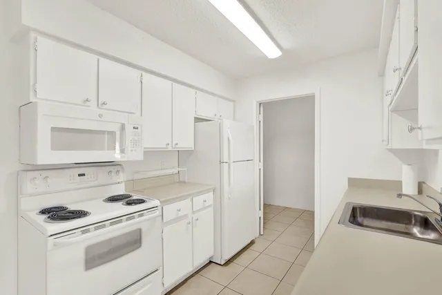 a kitchen with stainless steel appliances granite countertop a sink and cabinets