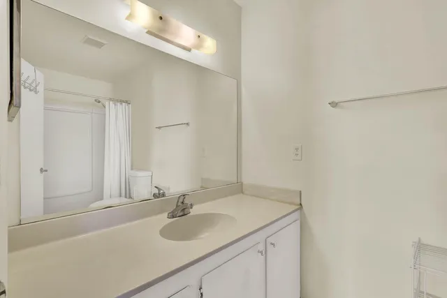 a white toilet sitting next to a shower curtain