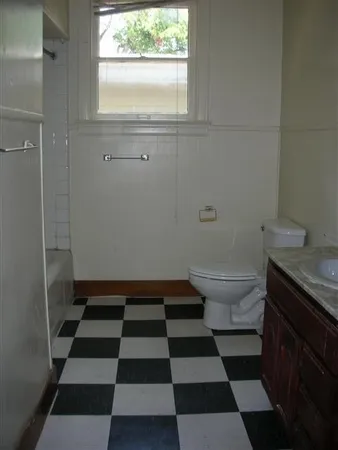 a bathroom with a black and white checkered floor
