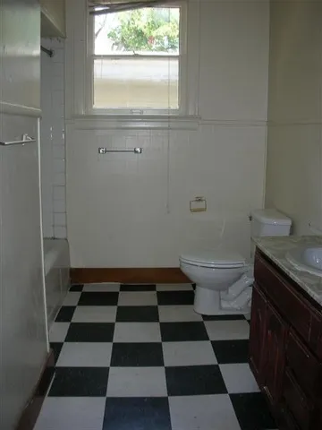 a bathroom with a black and white checkered floor