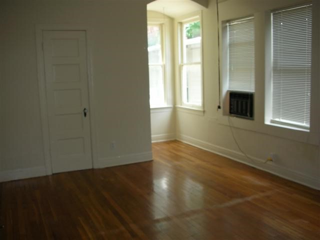 2800 Whitis Avenue, Unit D Austin, TX 78705 - Photo 3 of 6 an empty room with wooden floor and windows