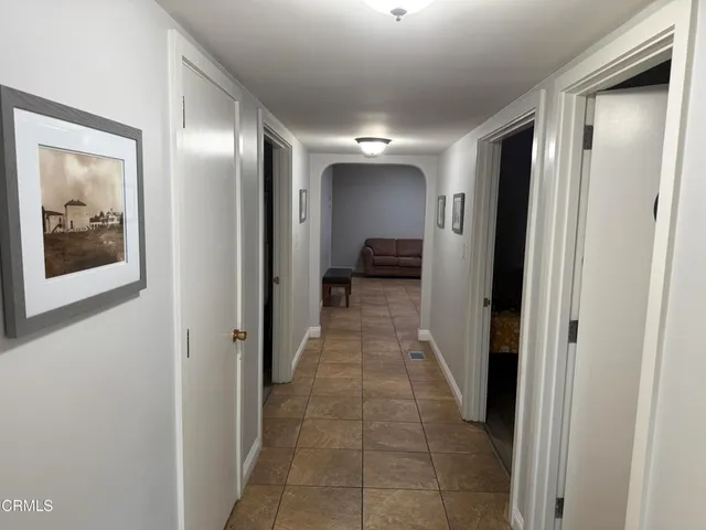 a view of a hallway with wooden shelves