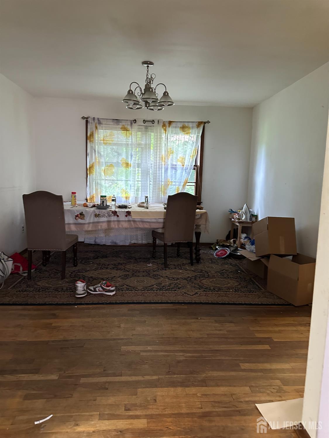 16 Hershey Road East Brunswick, NJ 08816 - Photo 11 of 15 a living room with furniture and a chandelier