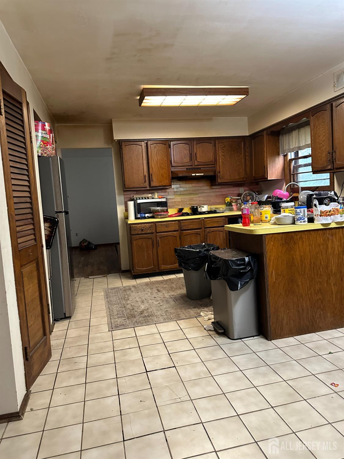 16 Hershey Road East Brunswick, NJ 08816 - Photo 6 of 15 a kitchen with a sink a stove and refrigerator