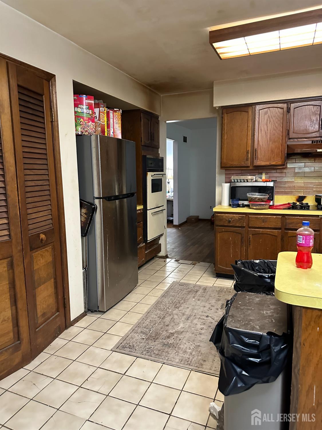 16 Hershey Road East Brunswick, NJ 08816 - Photo 9 of 15 a kitchen with a refrigerator and a stove top oven