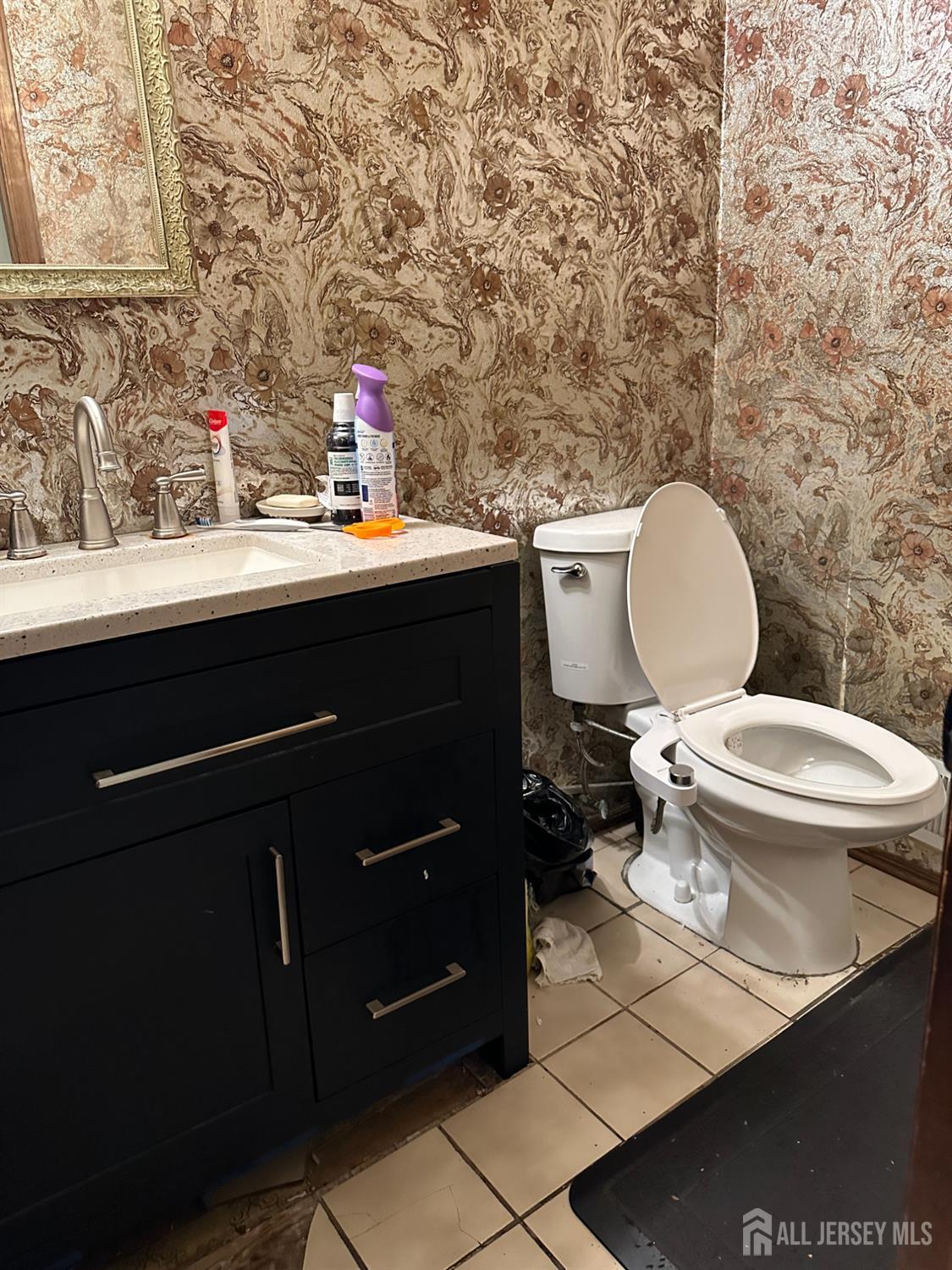 16 Hershey Road East Brunswick, NJ 08816 - Photo 10 of 15 a bathroom with a toilet sink and mirror