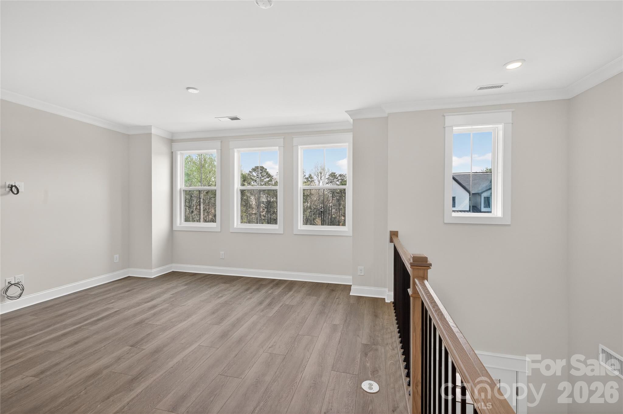 355 Linda Carol Lane Tega Cay, SC 29708 - Photo 13 of 15 a view of an empty room with wooden floor and a window