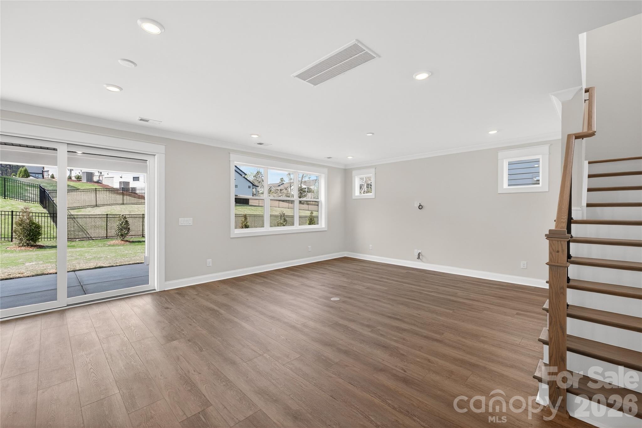 355 Linda Carol Lane Tega Cay, SC 29708 - Photo 8 of 15 an empty room with wooden floor and windows