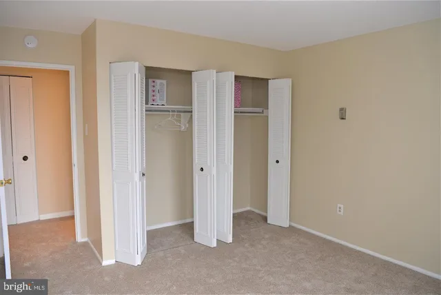 a view of an empty room with closet area