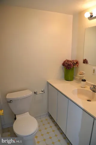 a white toilet sitting next to a bathroom sink