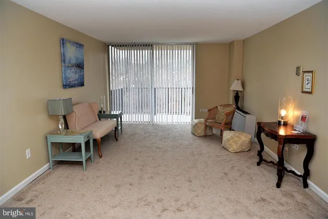a living room with furniture and a lamp