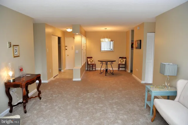 a living room with furniture and a dining table