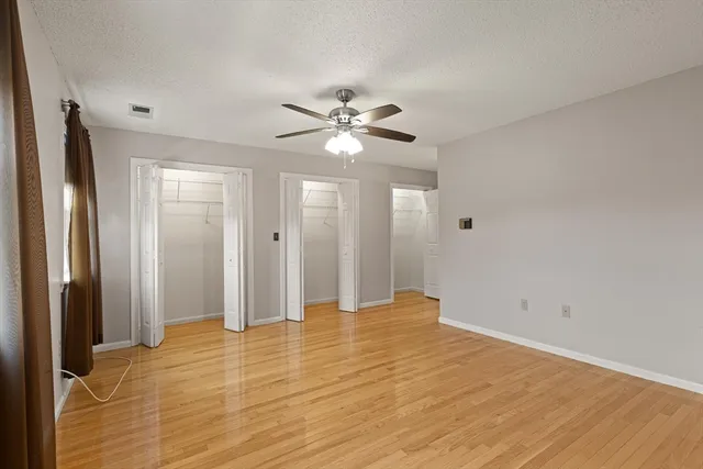 a view of an empty room with a ceiling fan