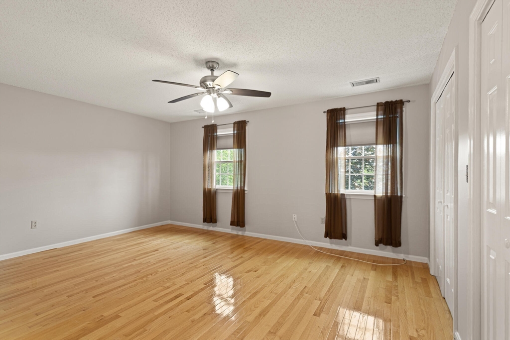 6 Countryside Lane, Unit 1303 Salem, MA 01970 - Photo 12 of 26 a view of an empty room with window and wooden floor