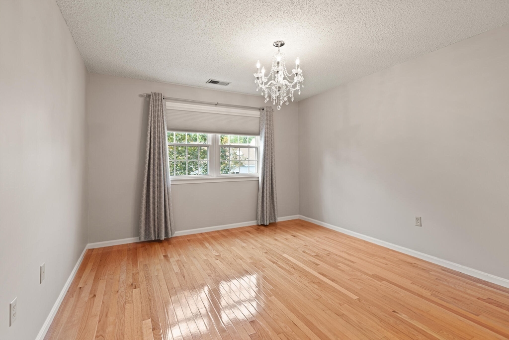 6 Countryside Lane, Unit 1303 Salem, MA 01970 - Photo 15 of 26 a view of a room with wooden floor and chandelier