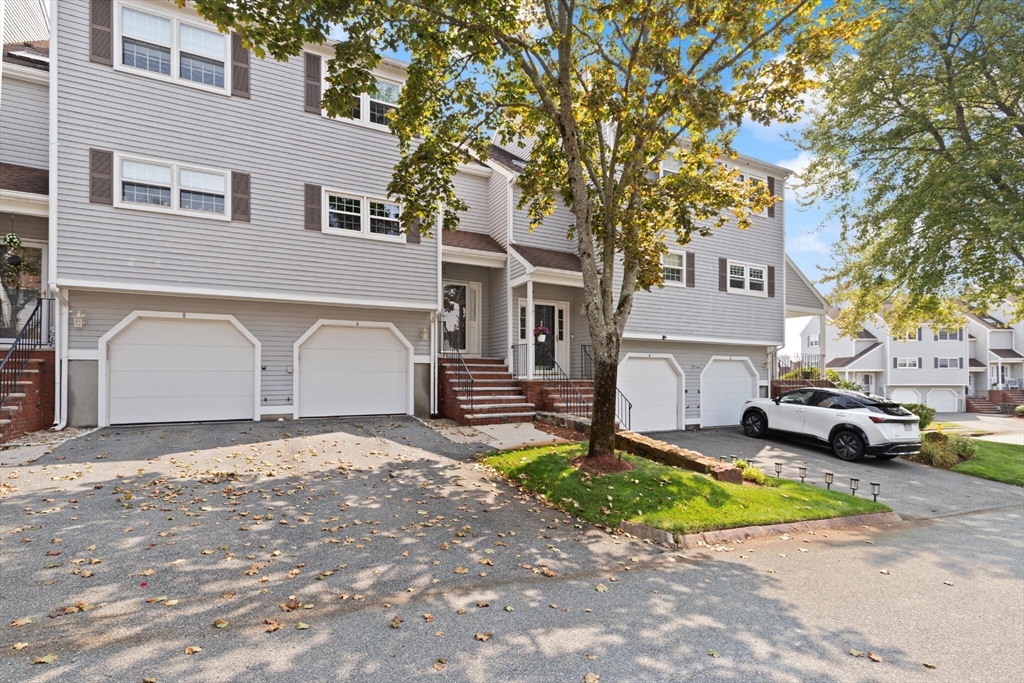 6 Countryside Lane, Unit 1303 Salem, MA 01970 - Photo 2 of 26 a view of a white house in front of a yard with parked cars