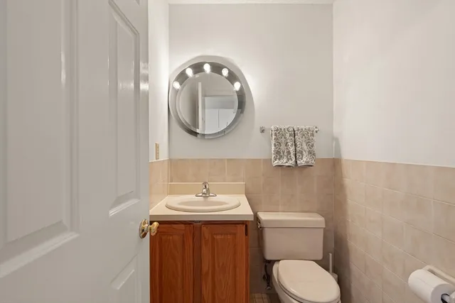 a bathroom with a toilet a sink and mirror