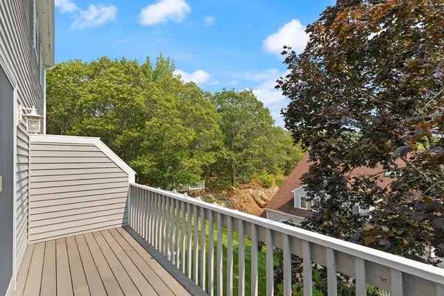 a view of a balcony with wooden floor and fence