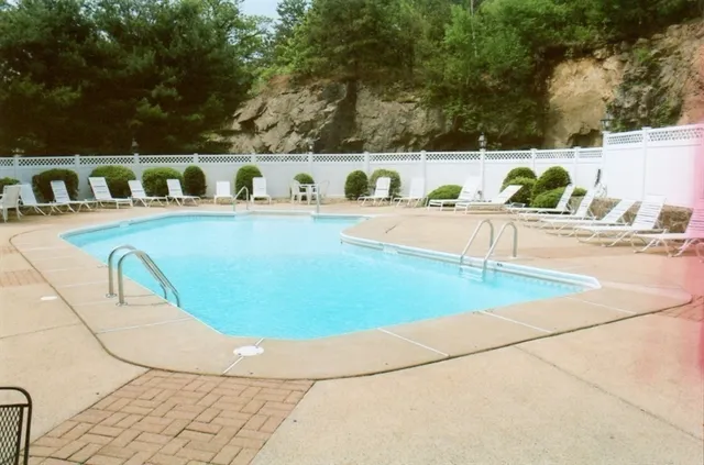 a view of a swimming pool with furniture