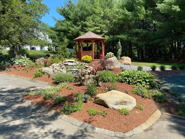 a front view of a house with a yard and lake