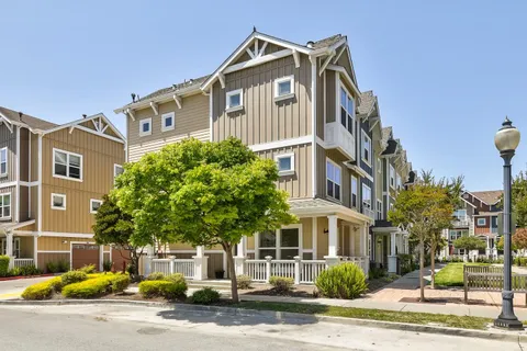 a front view of a residential apartment building with a yard