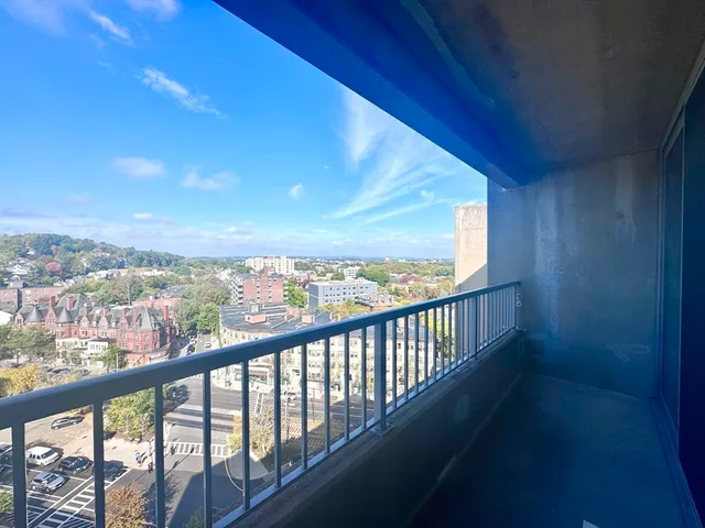 a view of city and mountain from a balcony