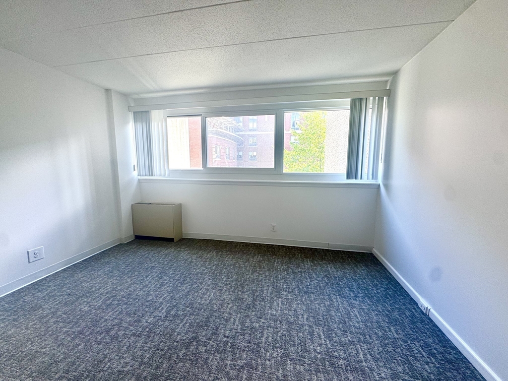 133 Park Street, Unit 703 Brookline, MA 02446 - Photo 10 of 25 an empty room with a window