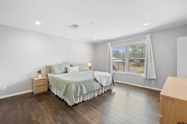a spacious bedroom with a bed and a large window