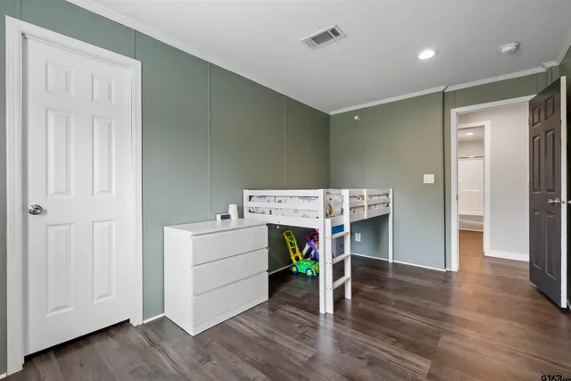 a view of an empty room and wooden floor