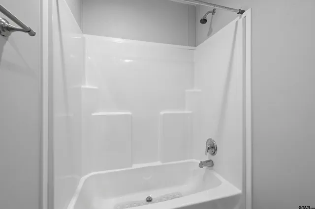 a bathroom with a white bath tub