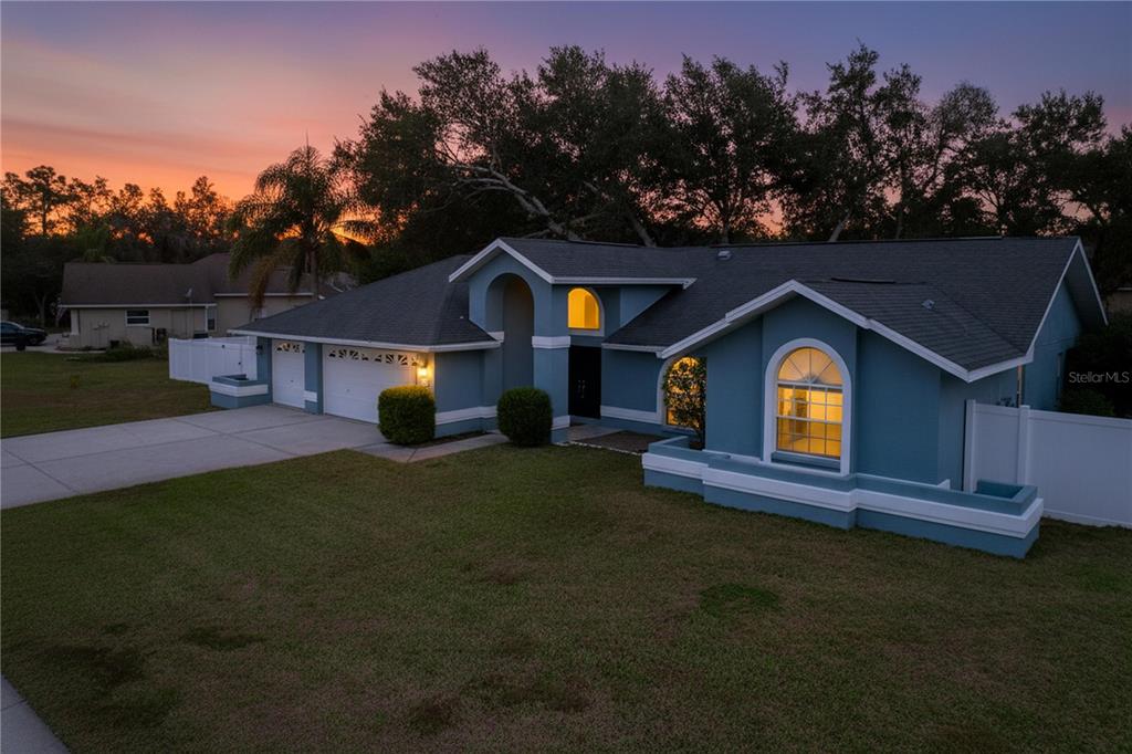 18812 Bascomb Lane Hudson, FL 34667 - Photo 11 of 57 a front view of a house with a yard