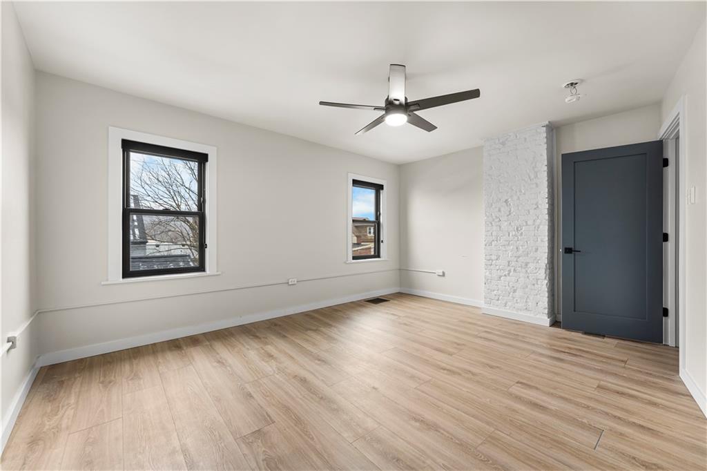 5322 Kent Way Pittsburgh, PA 15201 - Photo 19 of 24 a view of an empty room with wooden floor and a window